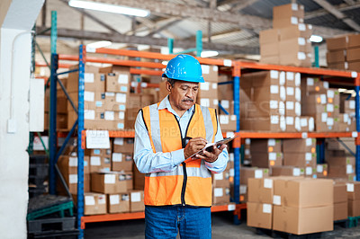 Buy stock photo Shot of a mature man doing inventory in a warehouse
