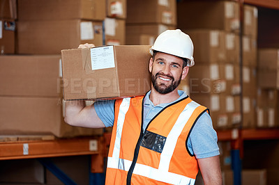 Buy stock photo Portrait of a young man holding a box while working in a warehouse