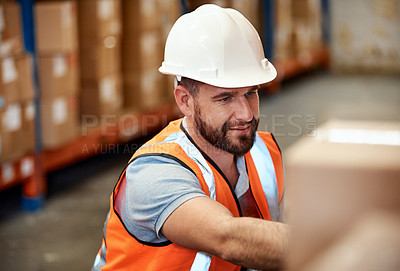 Buy stock photo Shot of a young man working in a warehouse