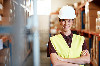 Buy stock photo Portrait of a young woman standing in a warehouse