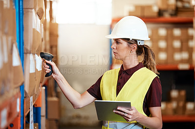 Buy stock photo Shot of a young woman using a barcode reader and digital tablet in a warehouse