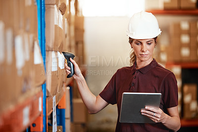 Buy stock photo Shot of a young woman using a barcode reader and digital tablet in a warehouse