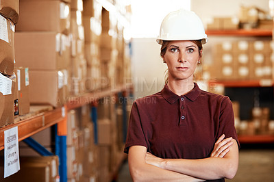 Buy stock photo Portrait of a young woman standing in a warehouse