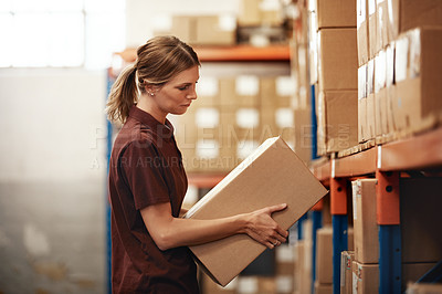 Buy stock photo Shot of a young woman working in a warehouse