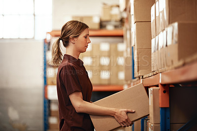 Buy stock photo Shot of a young woman working in a warehouse