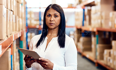Buy stock photo Portrait of a mature factory manager using a digital tablet in a warehouse