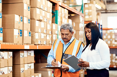 Buy stock photo Shot of a mature man and woman working together in a warehouse
