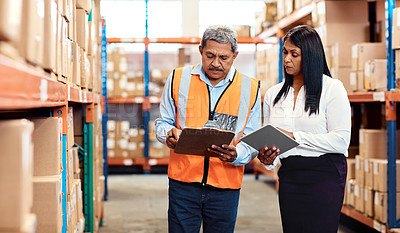 Buy stock photo Shot of a mature man and woman working together in a warehouse