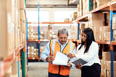 Buy stock photo Shot of a mature man and woman working together in a warehouse