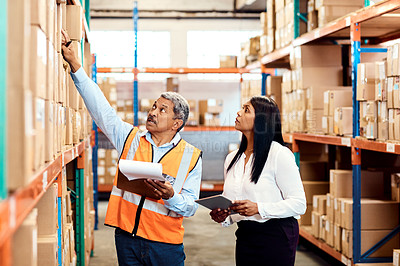 Buy stock photo Shot of a mature man and woman working together in a warehouse
