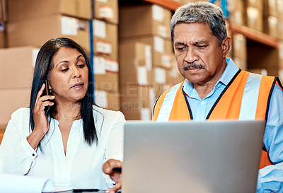 Buy stock photo Shot of a mature man and woman working together in a warehouse