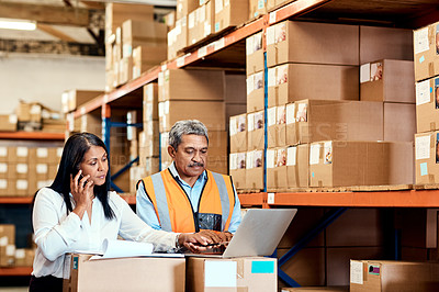 Buy stock photo Shot of a mature man and woman working together in a warehouse