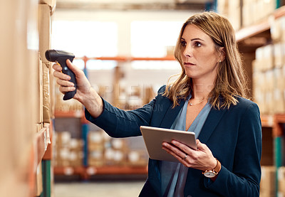 Buy stock photo Shot of a young factory manager using a barcode reader and digital tablet in a warehouse