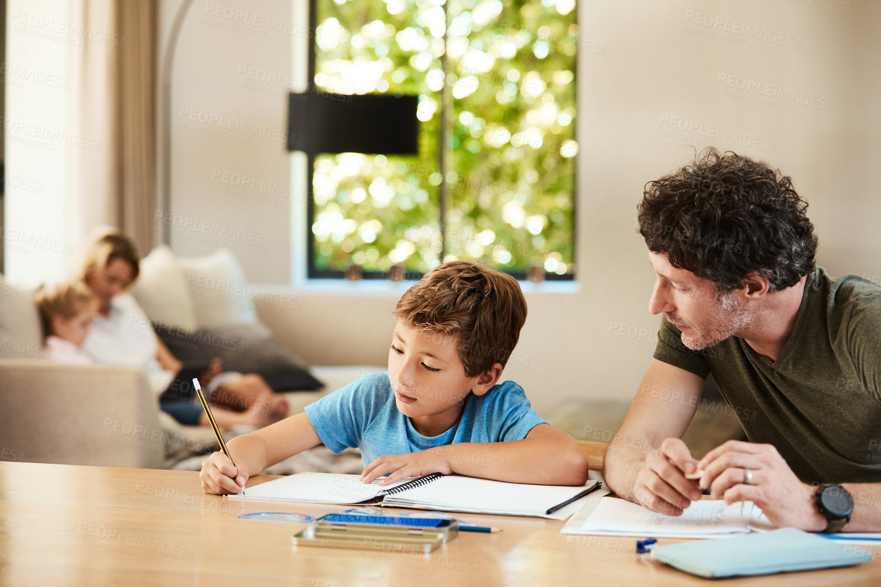 Buy stock photo Homework, help and dad with son for learning, assignment and teaching skills for development. Family, home and father with boy for writing, assessment and study for education, support and parenting