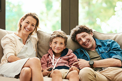Buy stock photo Shot of a happy family relaxing together on the sofa at home