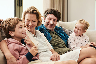 Buy stock photo Shot of a happy family relaxing together on the sofa at home