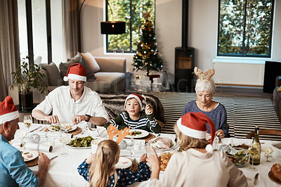 Buy stock photo Cropped shot of a family having lunch together at a table during Christmas time
