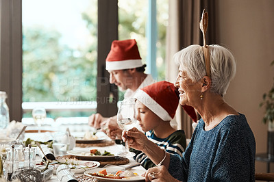 Buy stock photo Cropped shot of a family having lunch together at a table during Christmas time
