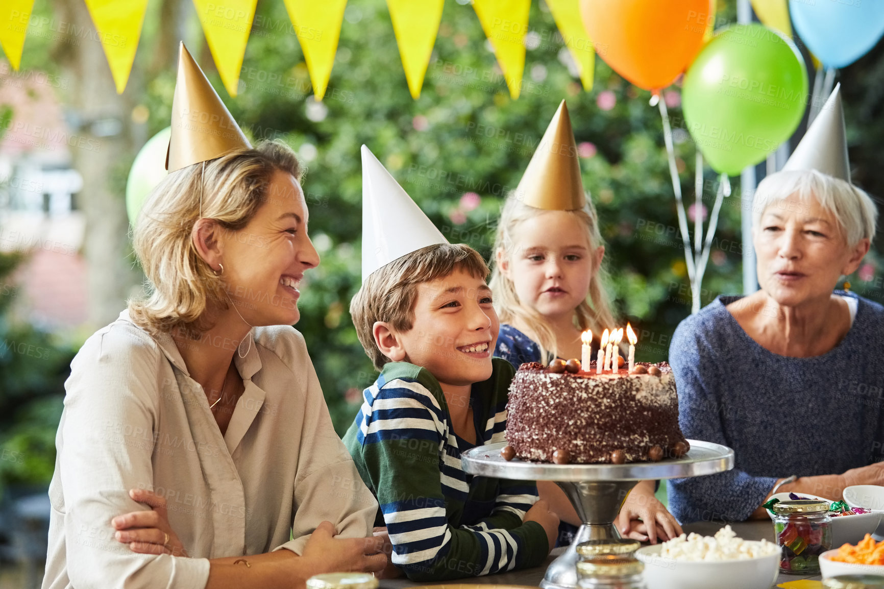 Buy stock photo Cake, singing and child in backyard for birthday party, family gathering and milestone tradition. Happy boy, mom and grandma in home garden for special event, generations and celebration with dessert
