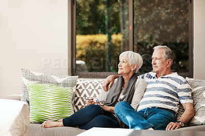 Buy stock photo Shot of a happy senior couple relaxing together on a sofa outside at home
