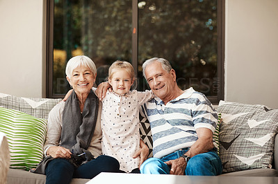 Buy stock photo Shot of an adorable little girl spending quality time with her grandmother and grandfather outside at home