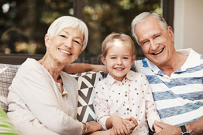 Buy stock photo Shot of an adorable little girl spending quality time with her grandmother and grandfather outside at home