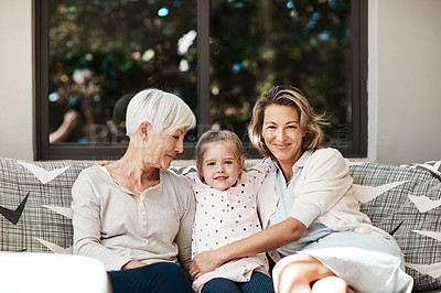 Buy stock photo Shot of a happy senior woman relaxing on the sofa with her daughter and granddaughter outside at home