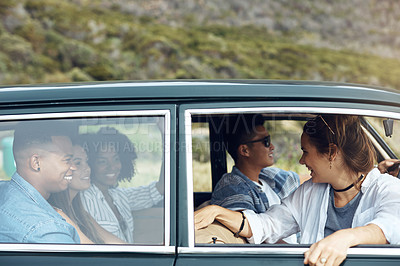Buy stock photo Shot of a group of happy young friends going on a road trip together