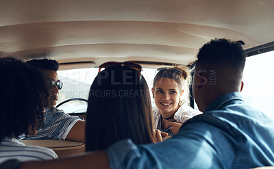Buy stock photo Shot of a group of happy young friends going on a road trip together