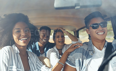 Buy stock photo Shot of a group of happy young friends going on a road trip together