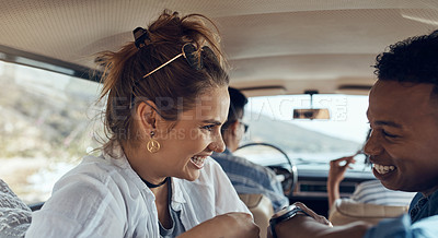 Buy stock photo Shot of a happy young couple going on a road trip with friends