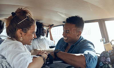Buy stock photo Shot of a happy young couple going on a road trip with friends