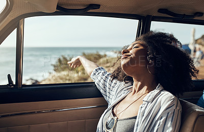 Buy stock photo Shot of a young woman enjoying a relaxing road trip