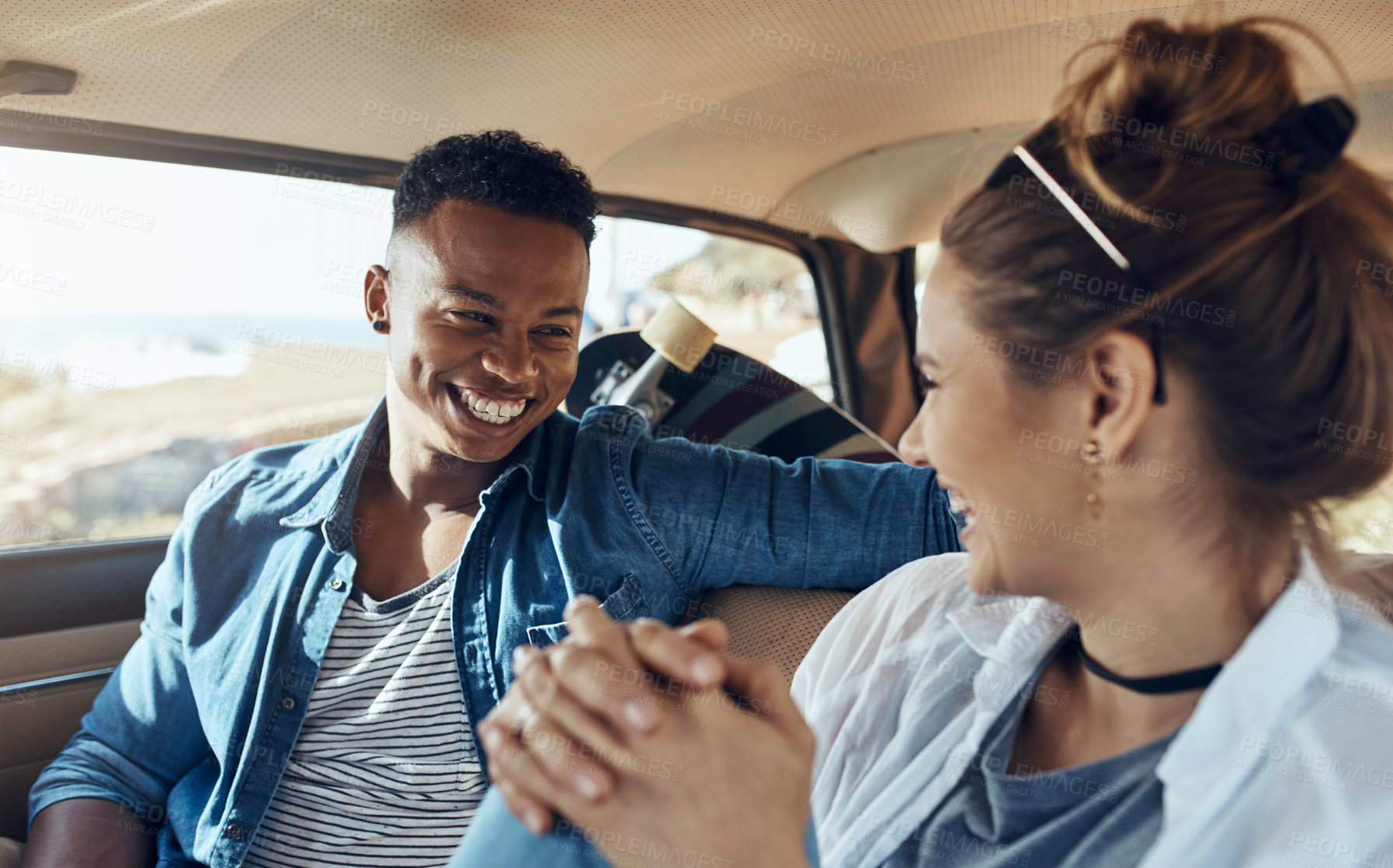 Buy stock photo Shot of a happy young couple going on a road trip together