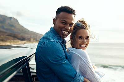 Buy stock photo Shot of a happy young couple sharing a romantic moment on a road trip along the coast
