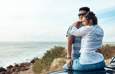 Buy stock photo Shot of a happy young couple looking at the view on a road trip along the coast