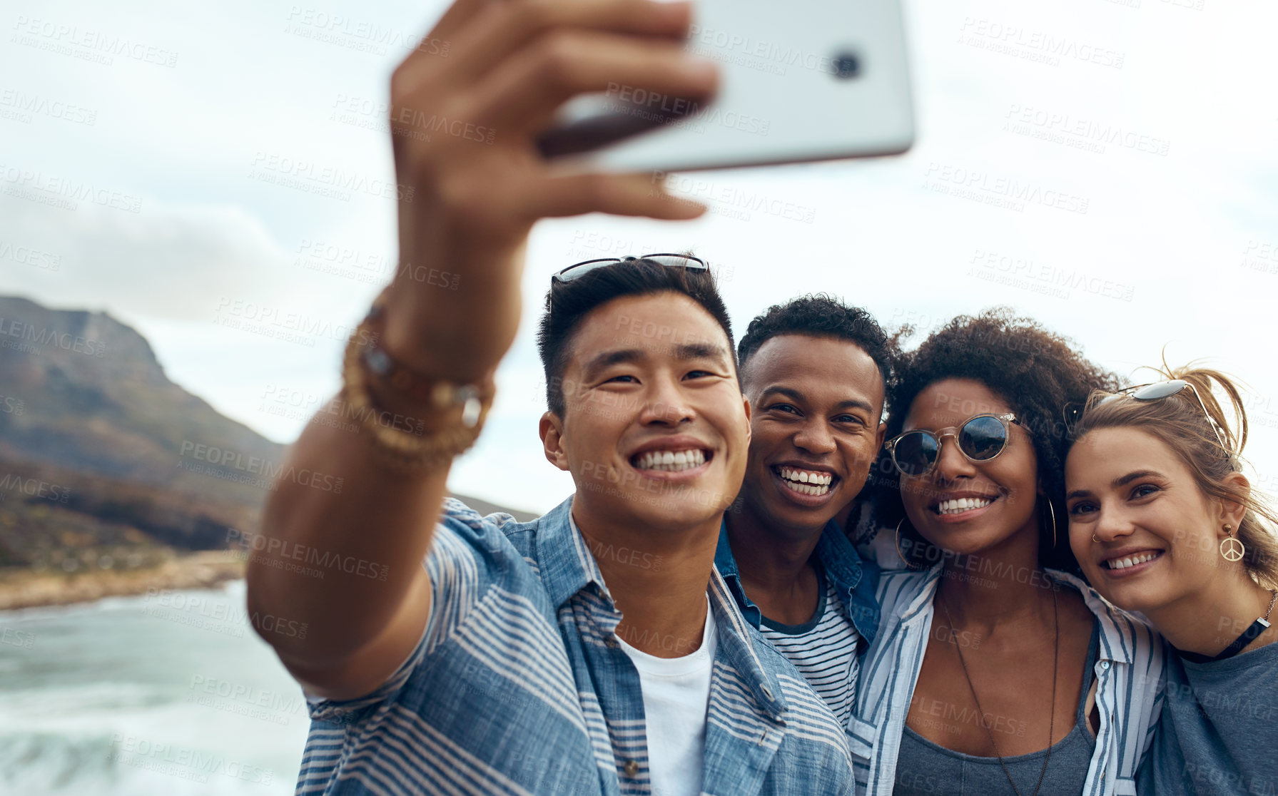 Buy stock photo Selfie, travel and smile with friends in at beach for social media post, vacation memory and bonding. Holiday photography, connection and support with group of people outdoor for picture and reunion