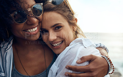Buy stock photo Shot of two happy young friends enjoying a vacation along the coast