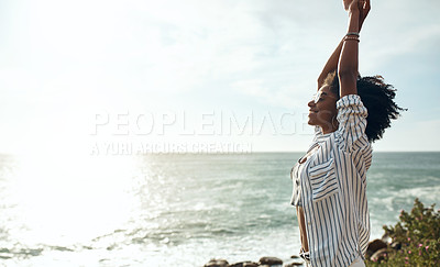 Buy stock photo Shot of an attractive young woman enjoying a vacation along the coast