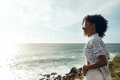 Buy stock photo Shot of an attractive young woman enjoying a vacation along the coast