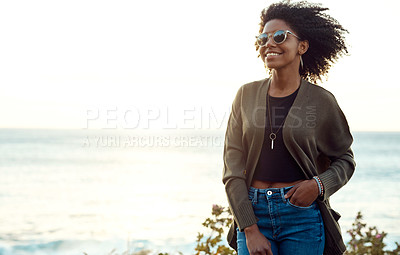 Buy stock photo Shot of an attractive young woman enjoying a vacation along the coast