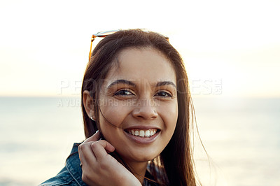 Buy stock photo Shot of an attractive young woman enjoying a vacation along the coast