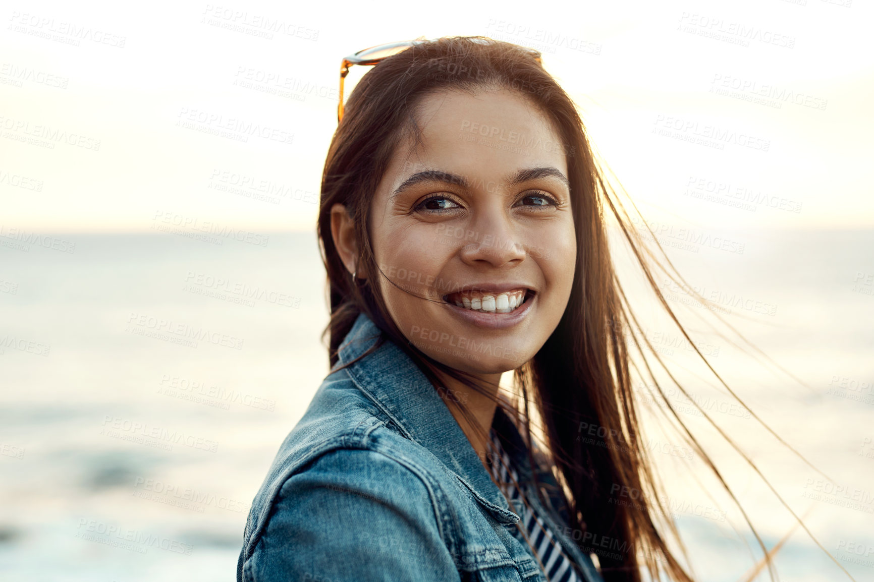 Buy stock photo Shot of an attractive young woman enjoying a vacation along the coast