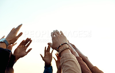 Buy stock photo Cropped shot of a group of friends raising their hands together in solidarity outdoors