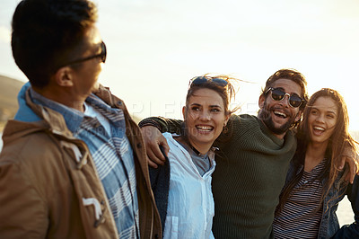 Buy stock photo Shot of a group of happy young friends enjoying a day outdoors