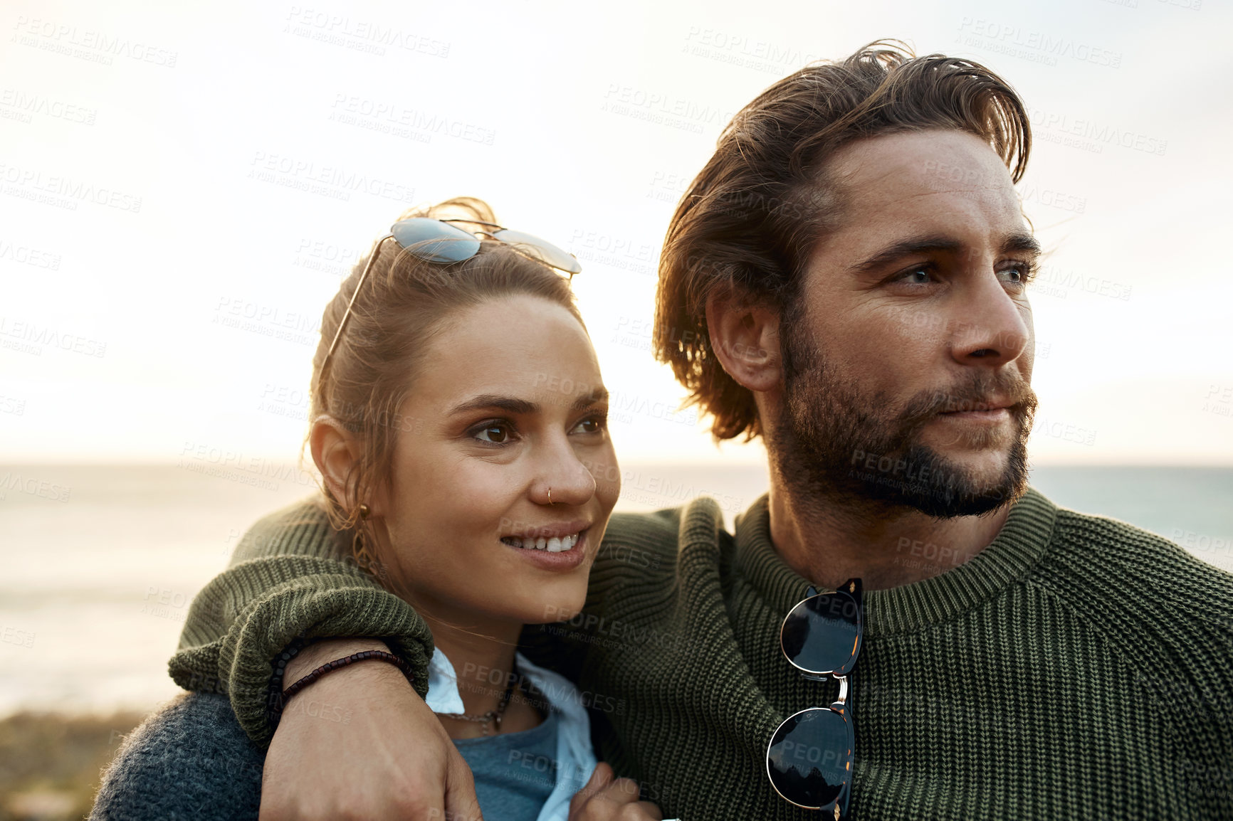 Buy stock photo hot of a happy young couple sharing a romantic moment on a vacation along the coast