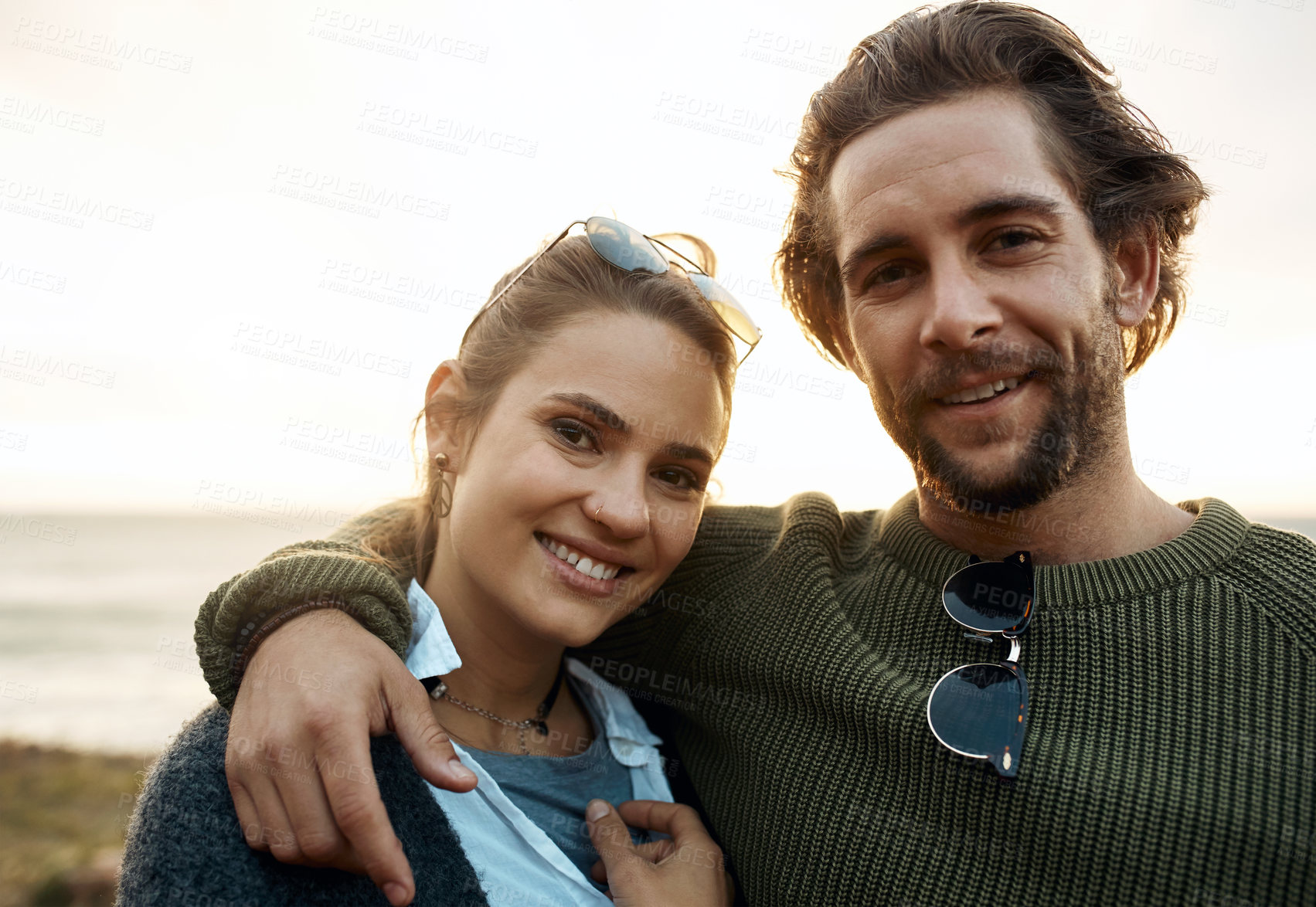 Buy stock photo hot of a happy young couple sharing a romantic moment on a vacation along the coast