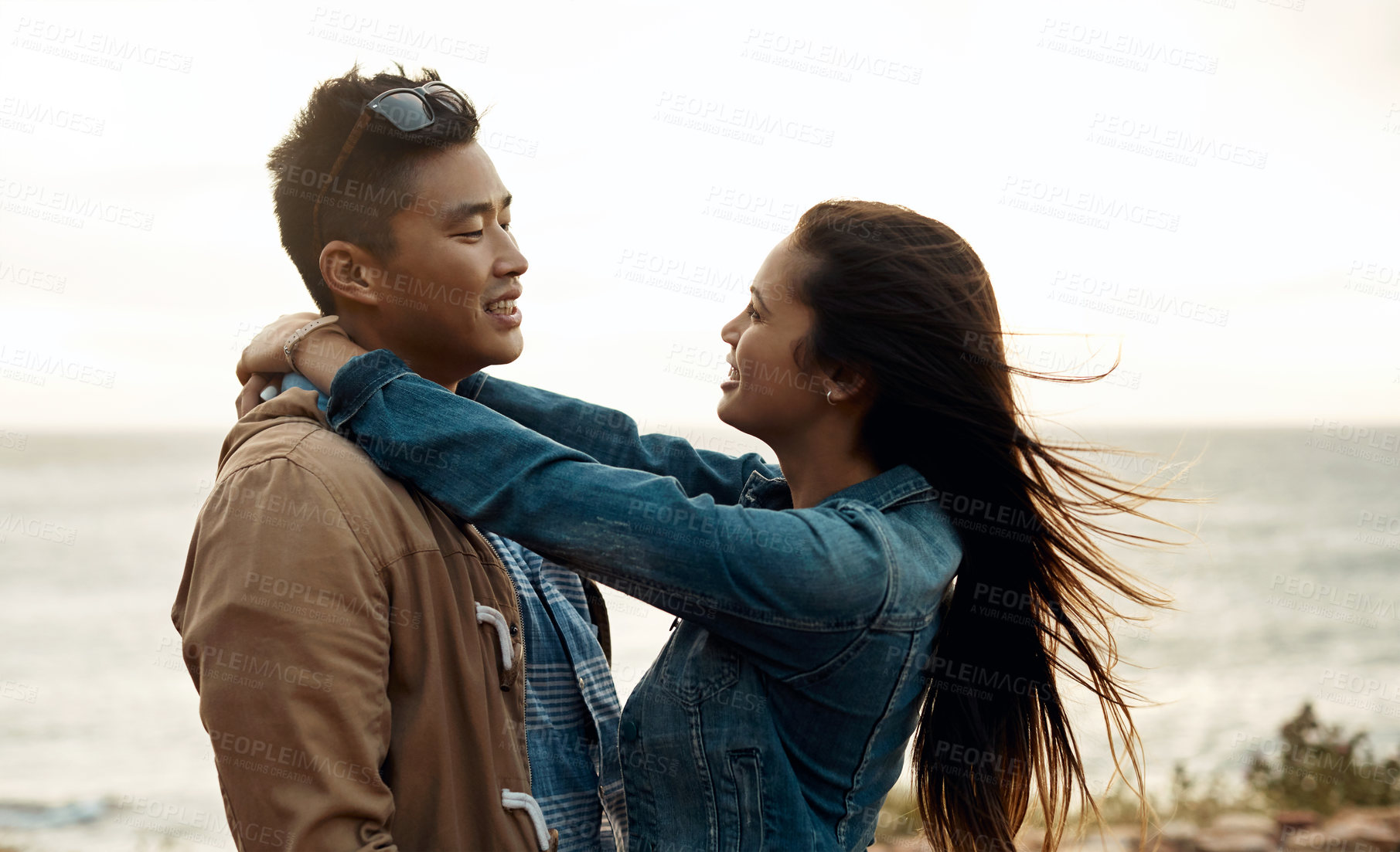Buy stock photo hot of a happy young couple sharing a romantic moment on a vacation along the coast