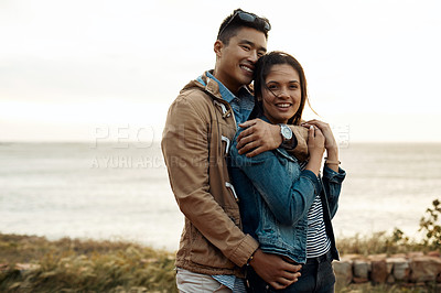 Buy stock photo hot of a happy young couple sharing a romantic moment on a vacation along the coast