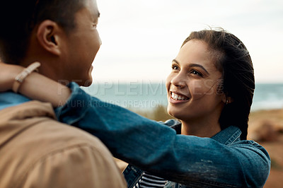 Buy stock photo hot of a happy young couple sharing a romantic moment on a vacation along the coast